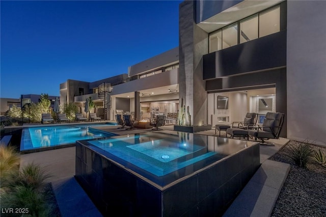 view of pool featuring a patio and a pool with connected hot tub