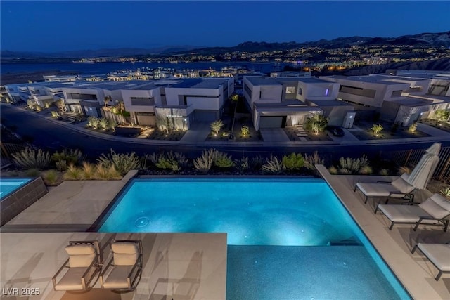 pool at night with a fenced in pool