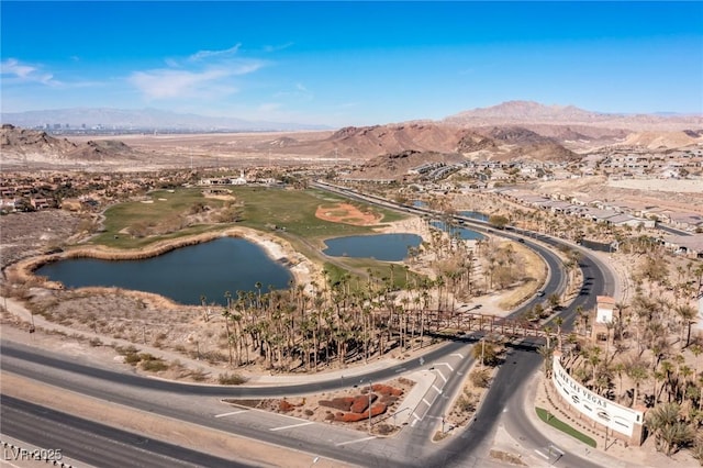 drone / aerial view featuring a water and mountain view