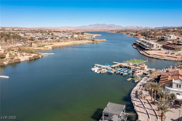 birds eye view of property with a water and mountain view