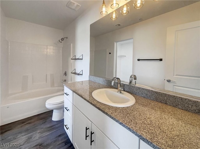 full bathroom with wood-type flooring, bathing tub / shower combination, toilet, and vanity