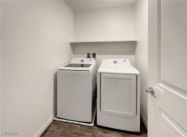 washroom with dark wood-type flooring and washing machine and clothes dryer