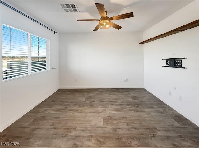 spare room featuring ceiling fan and dark hardwood / wood-style floors