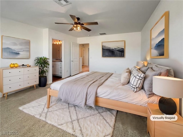 bedroom featuring sink, carpet, ensuite bath, and ceiling fan