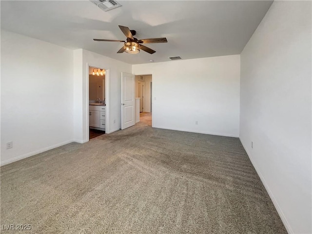 unfurnished room featuring sink, ceiling fan, and dark colored carpet