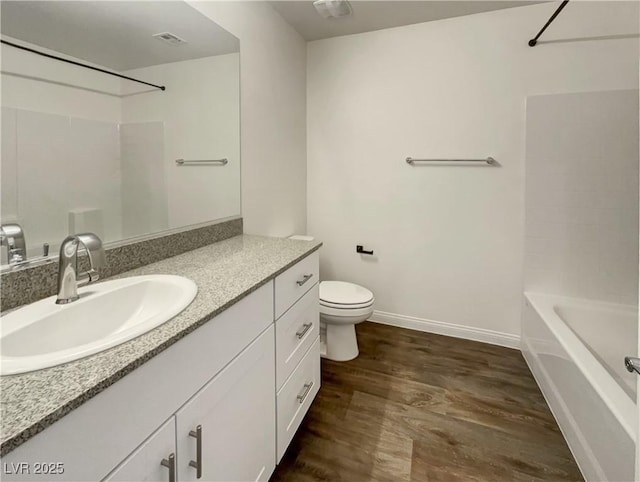 full bathroom featuring hardwood / wood-style floors, toilet, shower / bathing tub combination, and vanity