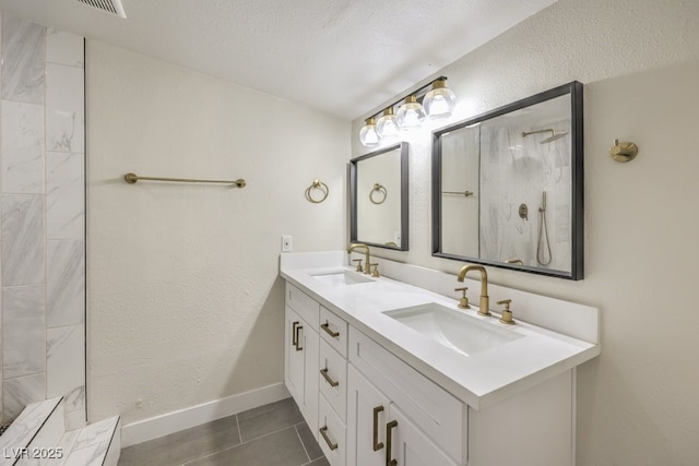 bathroom featuring vanity, a textured ceiling, and tile patterned flooring