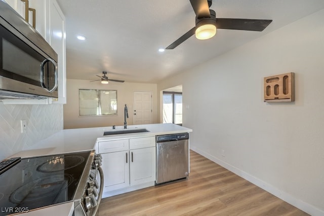 kitchen featuring sink, white cabinetry, decorative backsplash, and appliances with stainless steel finishes