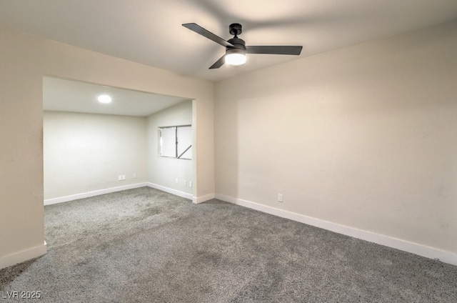 empty room with ceiling fan, carpet, and lofted ceiling