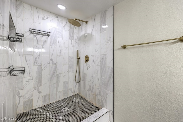 bathroom with a tile shower