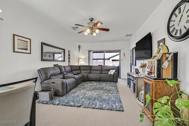 living room with ceiling fan and carpet