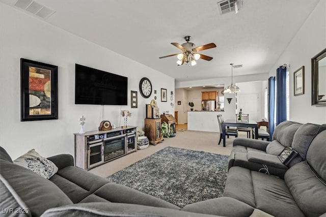 carpeted living room featuring ceiling fan