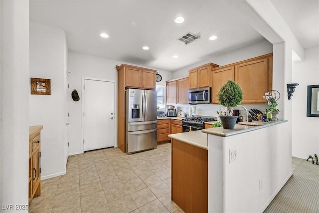 kitchen featuring appliances with stainless steel finishes and kitchen peninsula