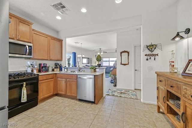 kitchen featuring sink, decorative light fixtures, appliances with stainless steel finishes, kitchen peninsula, and ceiling fan