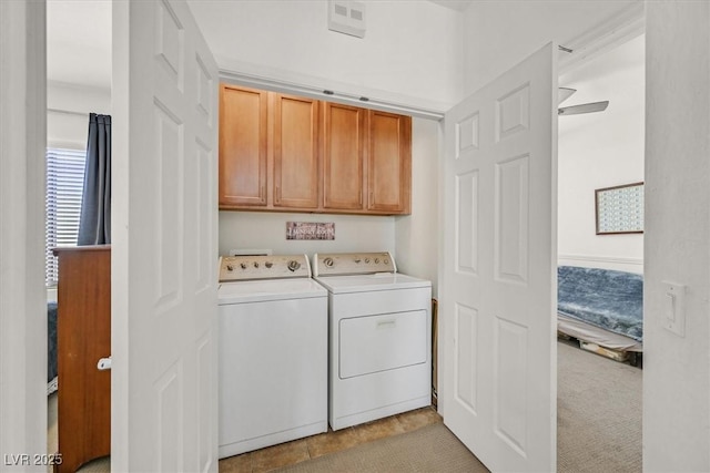 laundry room featuring cabinets, washer and dryer, and light tile patterned floors