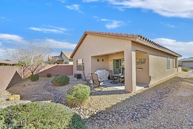 back of house featuring cooling unit and a patio