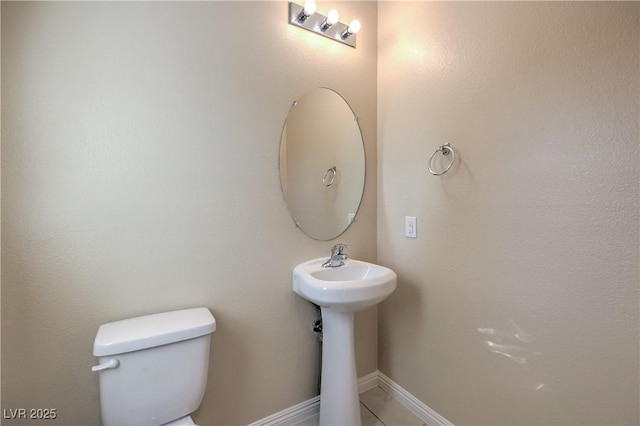 bathroom featuring tile patterned floors and toilet