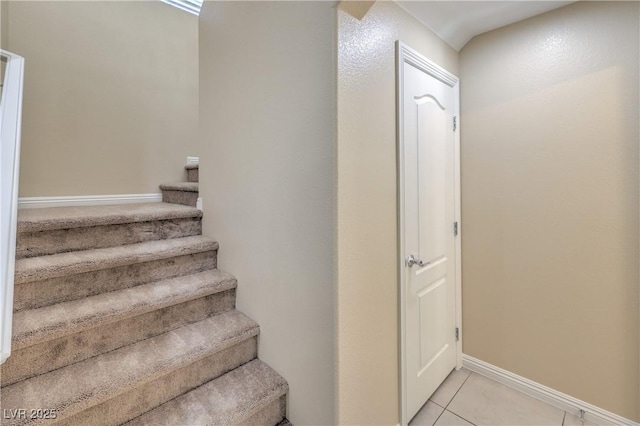 staircase featuring tile patterned flooring