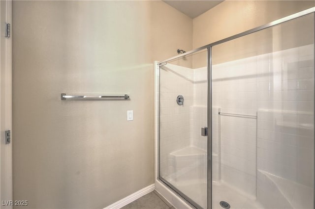 bathroom with walk in shower and tile patterned flooring