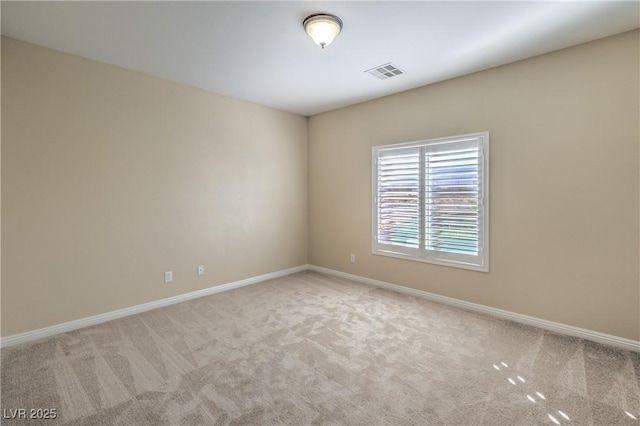 spare room with light colored carpet