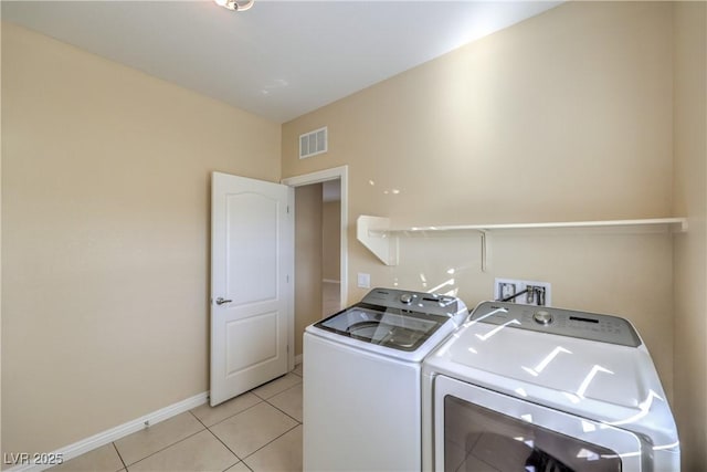 laundry room featuring light tile patterned floors and washer and dryer