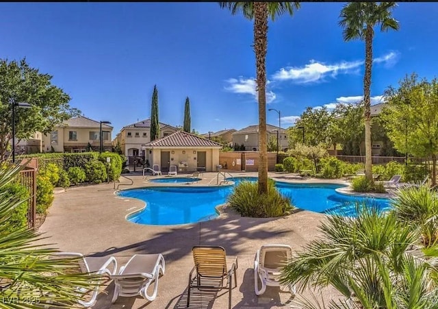 view of swimming pool featuring a patio area and a community hot tub