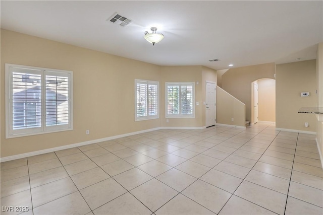 unfurnished room with light tile patterned flooring