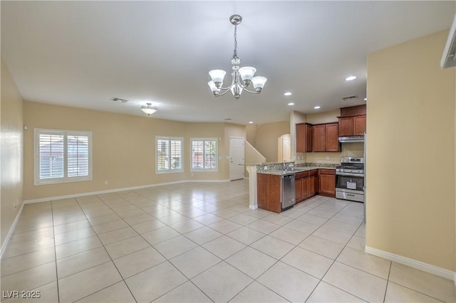 kitchen featuring sink, light stone counters, appliances with stainless steel finishes, and light tile patterned flooring