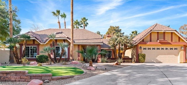 view of front of home featuring a garage and a front lawn