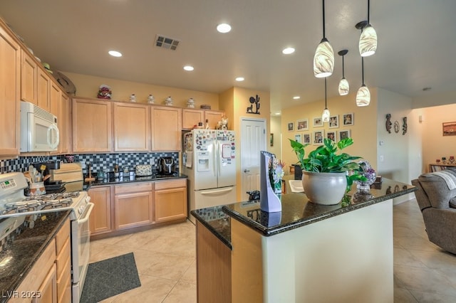 kitchen featuring pendant lighting, white appliances, light brown cabinets, dark stone counters, and light tile patterned floors