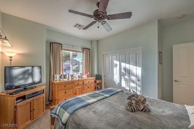 bedroom featuring ceiling fan, light colored carpet, and a closet