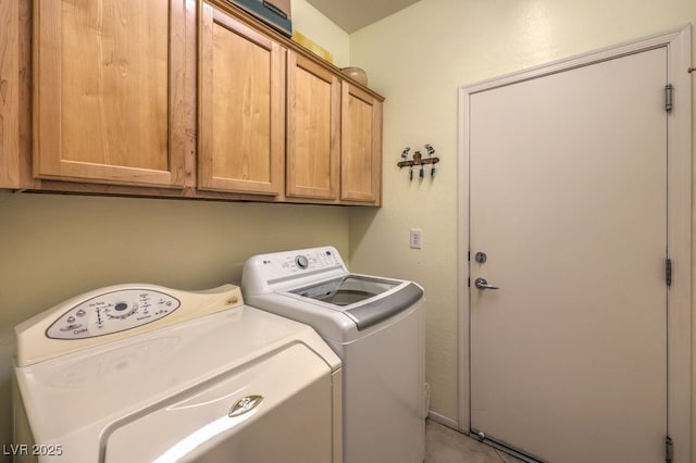 laundry area featuring cabinets and washing machine and clothes dryer