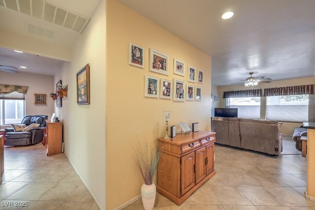 corridor featuring plenty of natural light and light tile patterned flooring