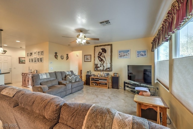 living room with light tile patterned flooring and ceiling fan