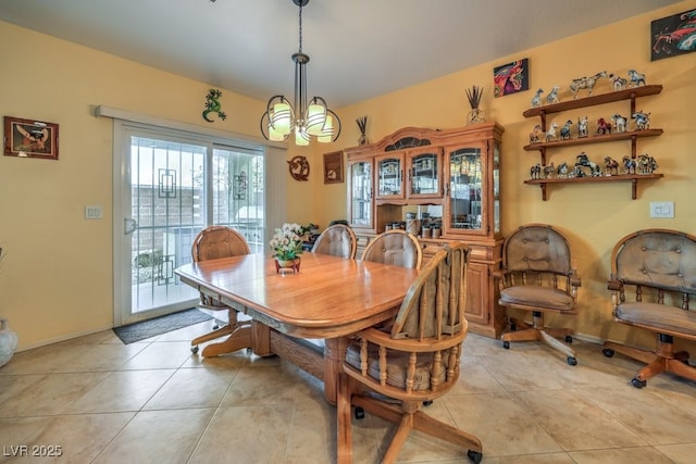 tiled dining room featuring an inviting chandelier