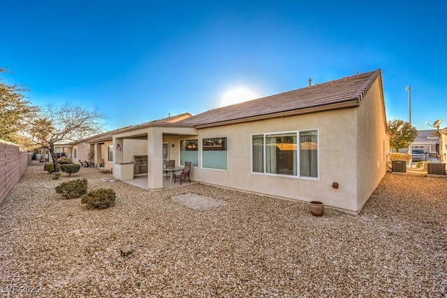 rear view of property featuring central AC and a patio