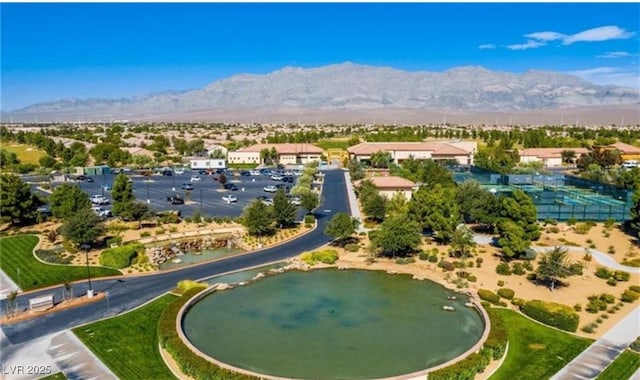 drone / aerial view featuring a water and mountain view