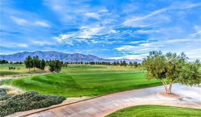 view of home's community featuring a mountain view and a lawn