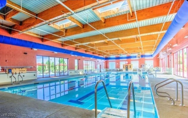 view of swimming pool featuring a skylight