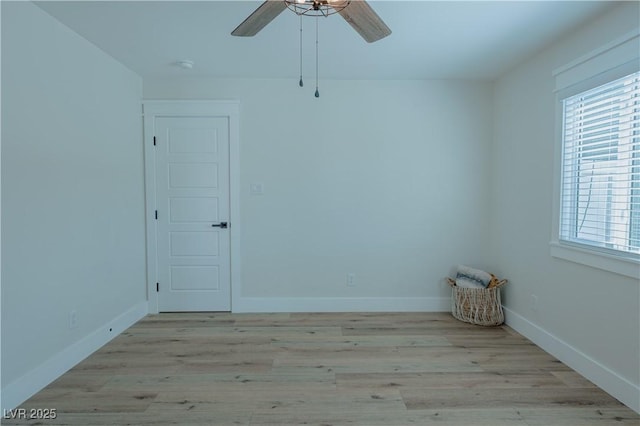 spare room with ceiling fan, light wood-type flooring, and a healthy amount of sunlight