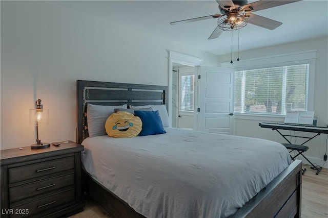 bedroom with ceiling fan and light hardwood / wood-style floors