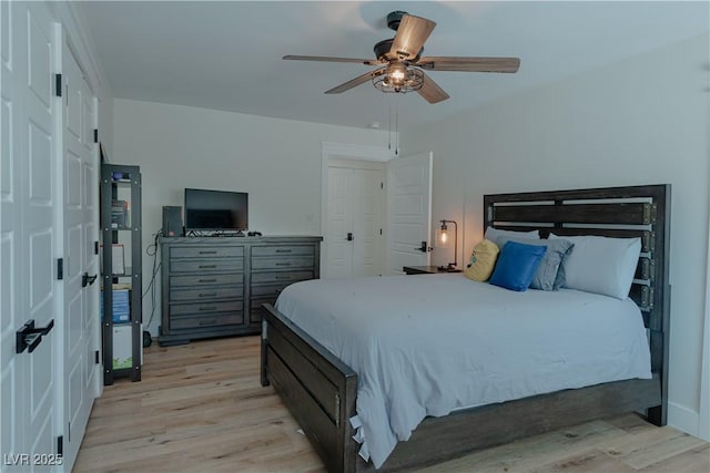 bedroom with light wood-type flooring and ceiling fan