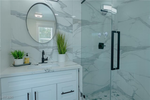 bathroom featuring walk in shower and vanity