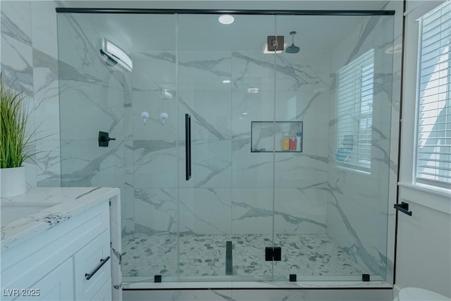 bathroom with an enclosed shower and vanity