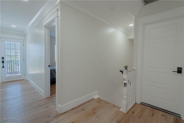 washroom with light wood-type flooring and ornamental molding