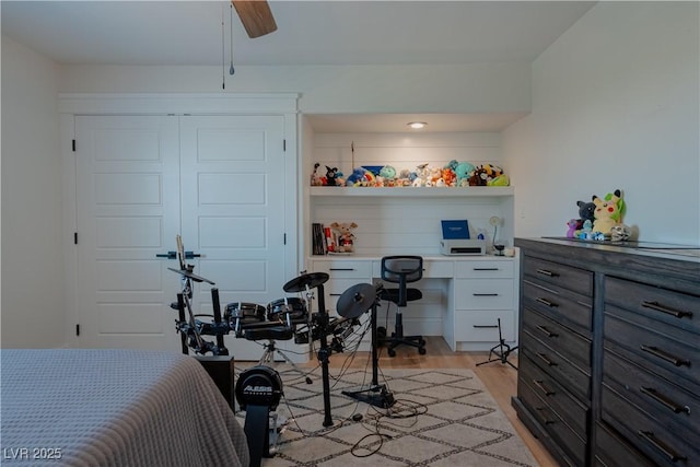 bedroom featuring light hardwood / wood-style floors and built in desk