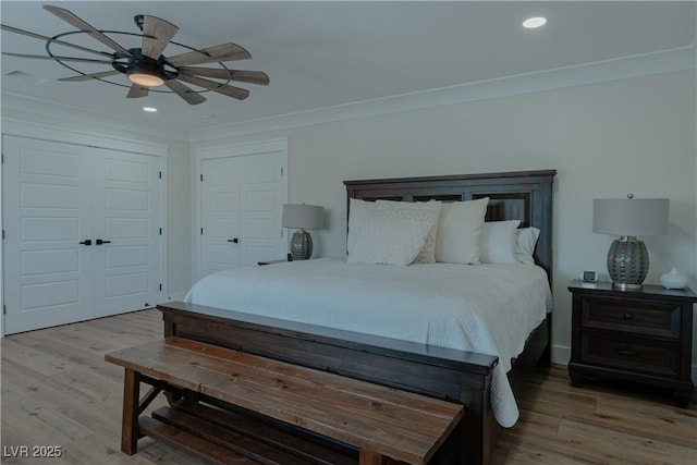 bedroom with ceiling fan, crown molding, and hardwood / wood-style flooring