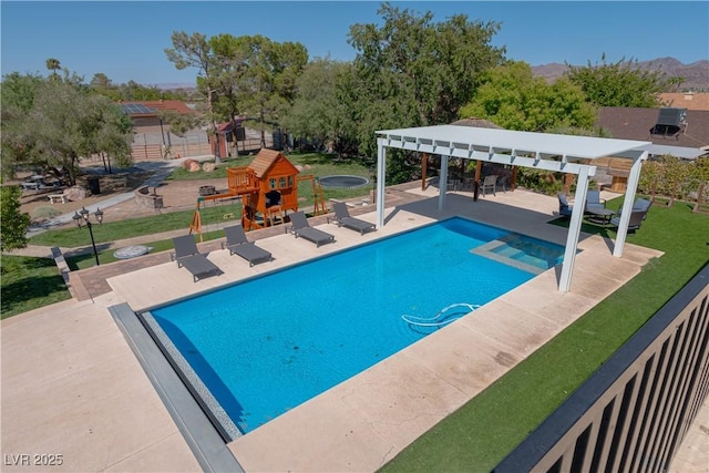 view of swimming pool with a mountain view, a patio area, and a pergola