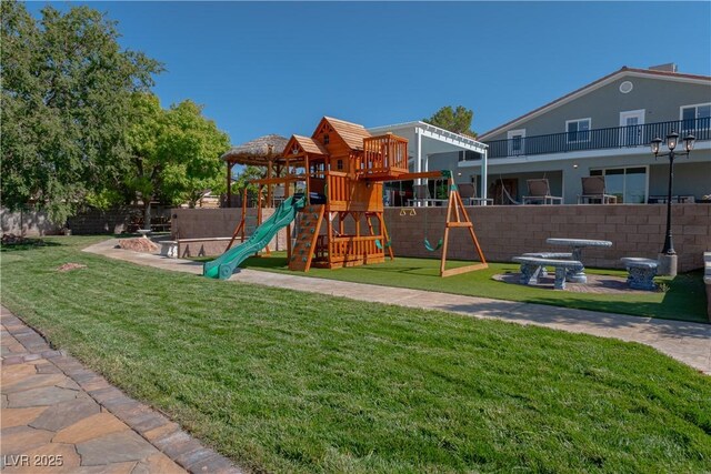 view of playground with a patio area and a lawn