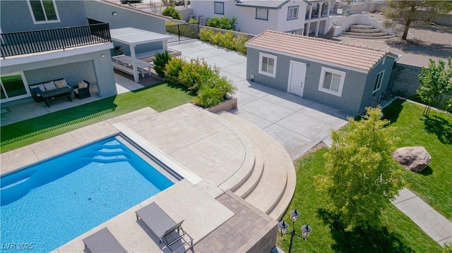 view of pool featuring a patio area, a yard, and an outdoor structure